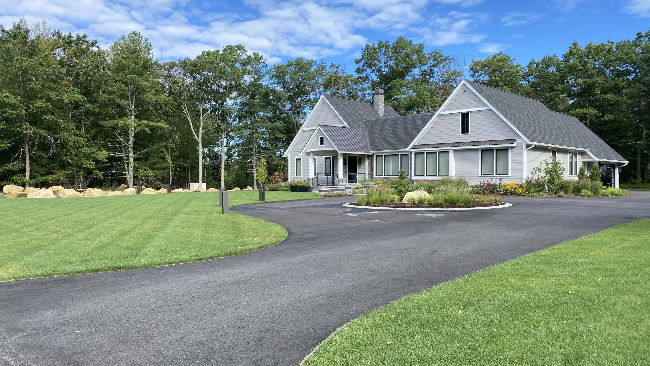 Lawn aeration overseeding Massachusetts yard in early fall with fresh grass seed